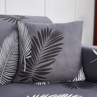 Stretch-Kissenbezug 45 × 45 cm — 1 Stück, Grau Palmen, auf einem Sofa